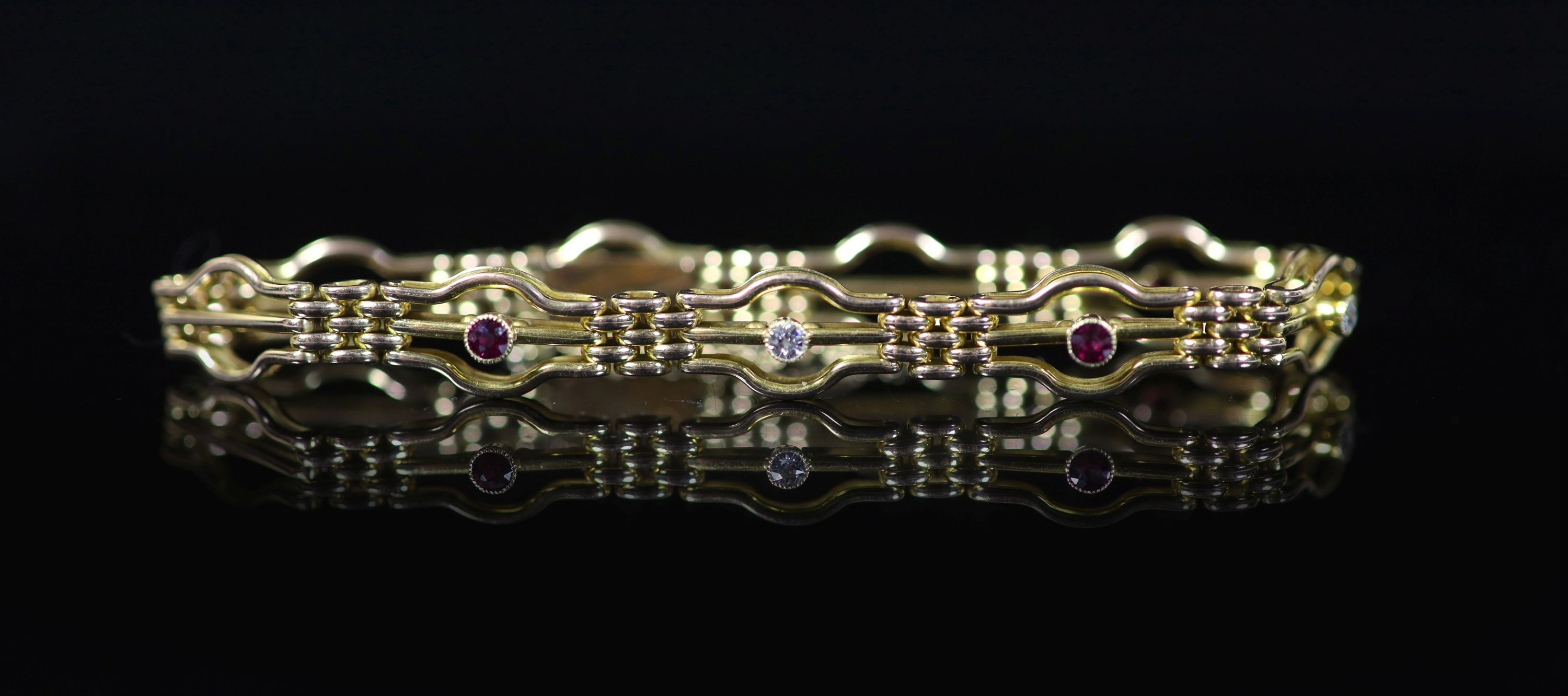An Edwardian 15ct gold, three stone ruby and two stone diamond set fancy link bracelet